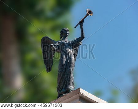 Ancient Greek Patroness Of Music. Sculpture Of An Ancient Muse Playing A Musical Instrument