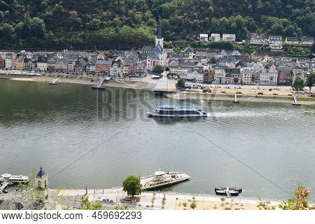 Sankt Goarshausen, Germany - 08 04 2022: Passenger Ship And Ferry On The Rhine With Sankt Goar In Ba