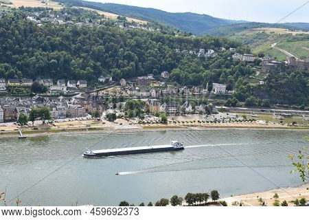 Sankt Goarshausen, Germany - 08 04 2022: Cargo Ship Passing Sankt  Goar During The Drought