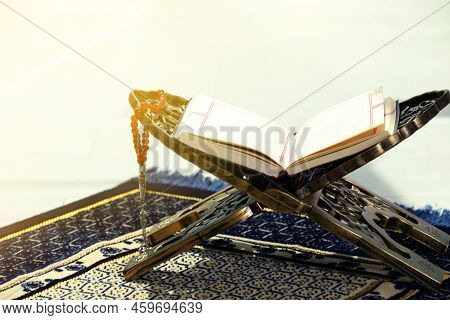Rehal With Open Quran And Misbaha On Muslim Prayer Rug Indoors