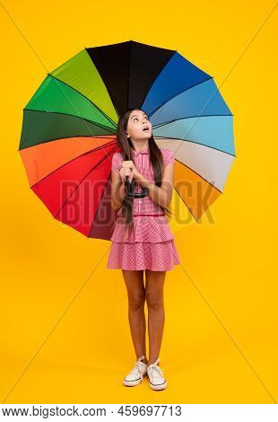 Shocked Surprised Teenager Girl. Summer Dress. Happy Teen Girl Holding Rainbow Umbella Standing Isol