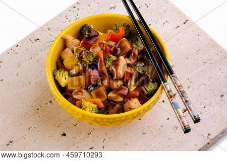 Chicken Yakisoba In Yellow Bowl Over Travertine Marble Stone