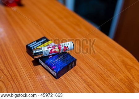 Miercurea Ciuc, Romania- 13 August 2022: Clipper Lighter On Pack Of Dunhill Cigarette On Kitchen Tab