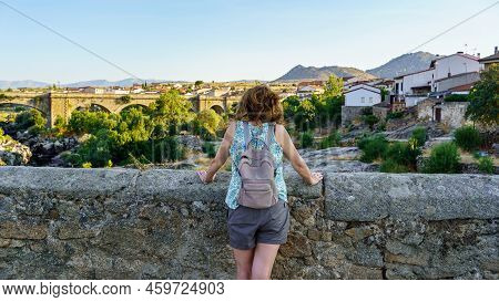 Tourist Woman Overlooking A Medieval Stone Bridge And Contemplating The Landscape, Puente Congosto, 