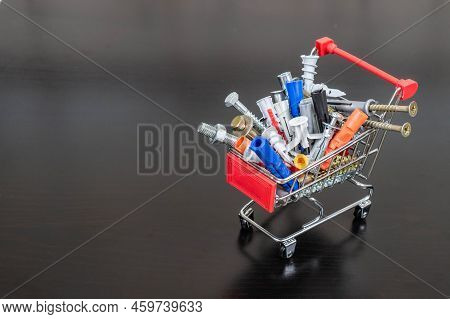 Different Types Of Fasteners In A Supermarket Trolley. Place For Text Or Logo. Concept: Fastener Sto
