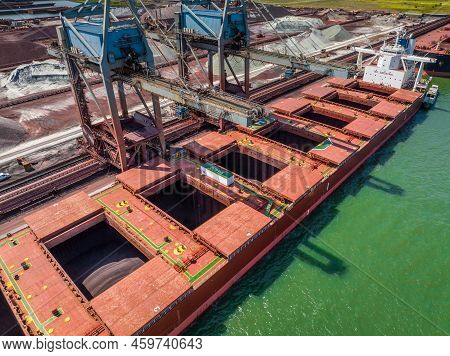 Bulk Carrier Ship Unloading Cargo At A Port Depot