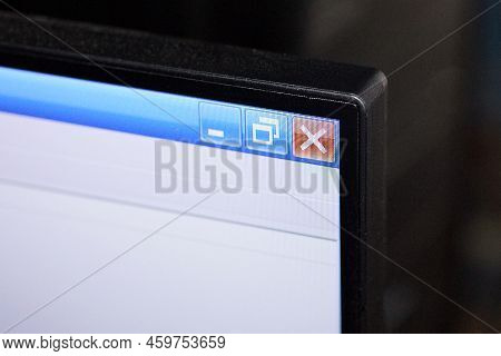 Corner Of A Monitor With A Screen With A White Browser And A Red Cross On A Blue Stripe
