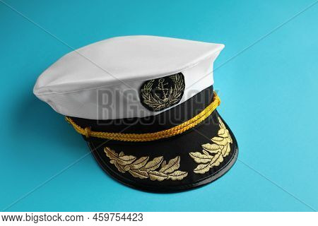 Peaked Cap With Accessories On Light Blue Background