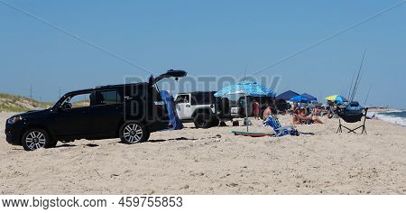 Dewey Beach, Delaware, U.s.a - August 13, 2022 - The Trucks With Tags Parked On The Surf Fishing Bea