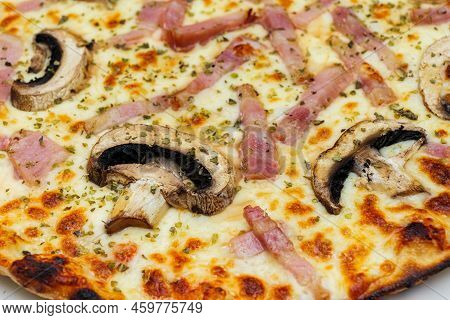 Close-up Of Pizza Topped With Mushrooms, Ham, Cheese And Oregano.