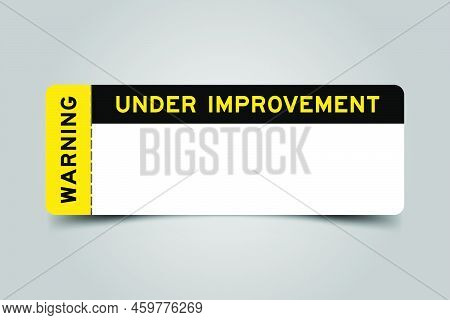 Yellow And Black Color Ticket With Word Under Improvement Warning And  And Have White Copy Psace On 