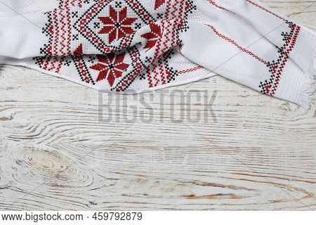 Beautiful Rushnyk On White Wooden Table, Top View With Space For Text. Ukrainian National Embroidery