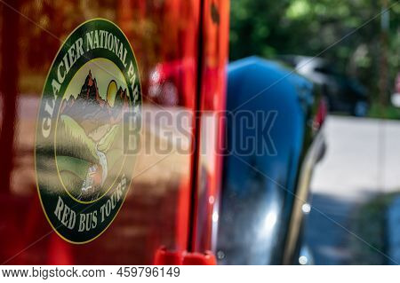Apgar, Montana, Usa - 8.2022 - Red Bus Jammer Tour Vehicle At Glacier National Park.