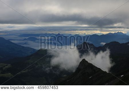 Sunrise Scene Seen From Mount Brienzer Rothorn. View Towards Stanserhorn And Lucerne. Fog Lifting Sl