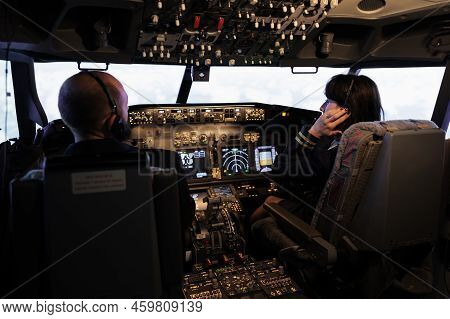 Team Of Airliner And Captain Using Power Switch On Cabin Dashboard To Fly Aircraft Jet. Aircrew Peop