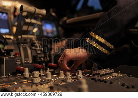 Woman Copilot Using Control Panel Command On Dashboard Navigation To Fly Ariplane In Cockpit. Female