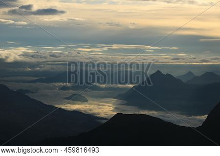 Sunrise View From Mount Brienzer Rothorn. Mount Stanserhorn And Sea Of Fog On A Cloudy Summer Mornin