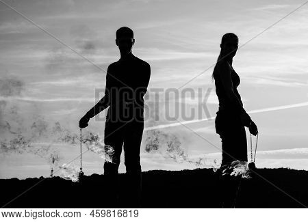 Couple Of Man And Woman In Dark Silhouettes Perform Burning Poi Dance During Fire Performance On Idy
