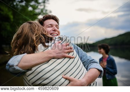 Friends Having Fun Together At Park Lauging And Hugging, Friendship And Lifestyle Concepts