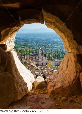 ASSISI, ITALY - OCTOBER 23: View of Assisi beautiful historical center with medieval Basilica of Saint Clare from Rocca Maggiore ruined walls October 23, 2019 in Assisi, Italy