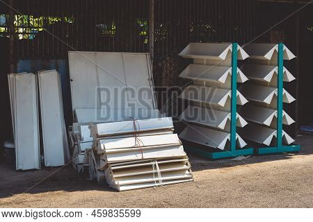 Empty Old Metal Book Or Magazines Shelves. Old Bookshelves That Are No Longer In Use Due To The End 