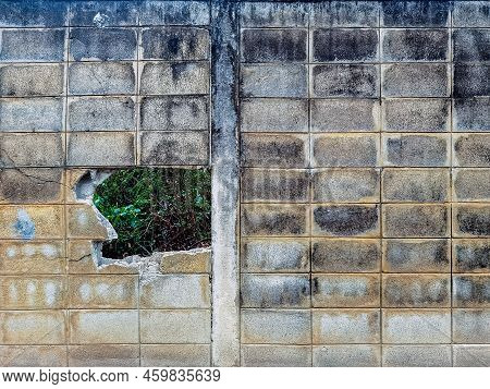 Dirty Old Eroded Cracked Plaster Cement Block Fence. Concrete Block Wall. Destroyed Crumbling Cement