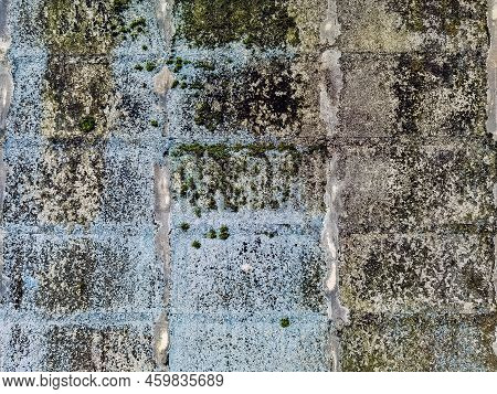 Dirty Old Eroded Cracked Plaster Cement Block Fence. Concrete Block Wall. Destroyed Crumbling Cement