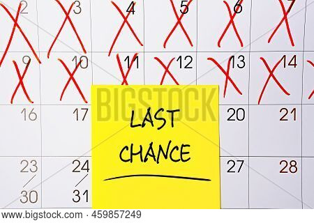 The Phrase Last Chance Written In Black Text On A Yellow Sticky Note Posted To A Calendar Page As A 