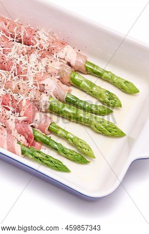 Ceramic Baking Dish With Aspargus Covered With Bacon Isolated On White Background