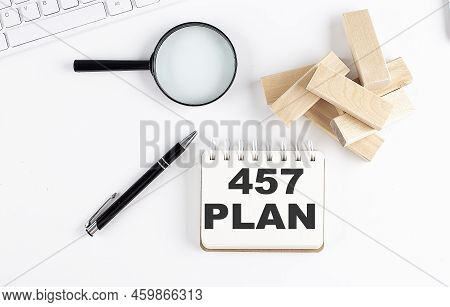 457 Plan Word Written On A Notebook With Block Magnifier And Pen , Business Concept.