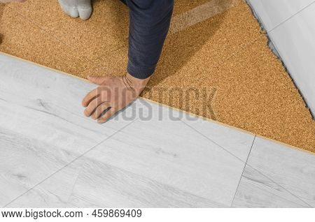 Unrecognizable Man Laying Laminate Flooring. Repair In The Apartment. Professional Laying Of A Floor