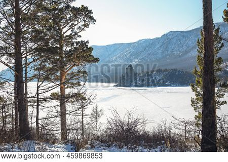 Aerial View Of A Sandy Bay, Mountains And Blue Ice Of Frozen Lake Baikal In Winter Time