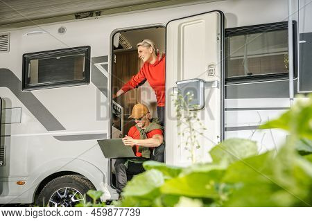 Happy Caucasian Family In Their Motorhome Doing Their Daily Activities During A Stopover. Smiling Co