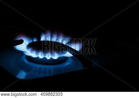 The Blue Flame Of The Gas Stove Burner On A Black Background. The Concept Of Energy Risis. Selective