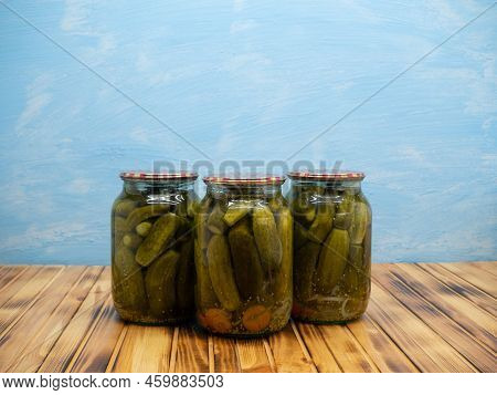 Preservations, Conservation. Salted, Pickled Cucumbers In A Jars On An Wooden Table. Pickling Cucumb