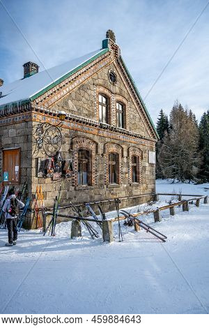 Orle, Poland - January 16, 2022: Historical Tourist Hut On Sunny Winter Day With Cross-country Skier