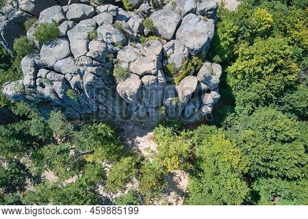 Aerial View Of Large Rocky Formations With Snone Boulders And Mountain High Cliffs