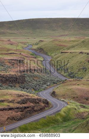 Scenic Road In The Countryside By Green Farm Fields. Near Washtucna, Washington, United States.