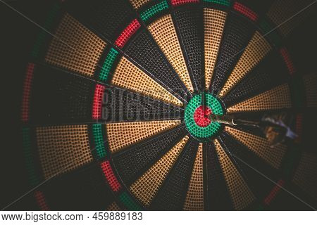 Business Concept - Target And Goal As Concept. Dart Arrow Hit On Bulleyes Of Dartboard To Represent 