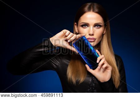 Beautiful Woman Handling Phon. Bright Makeup And Beautiful Hairstyle