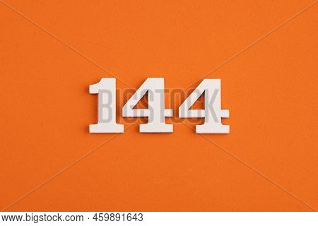 White Wooden Number 144 On Eva Rubber Orange Background
