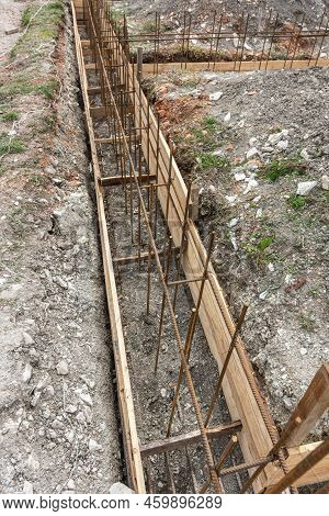 Fragment Of Reinforcement Of The Strip Foundation, The Trench Is Partially Covered With Earth