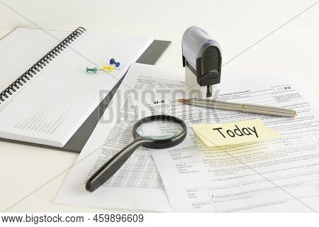 Blank W4 Tax Form, Magnifying Glass And A Pen On Table, Tax Season, Business Concept