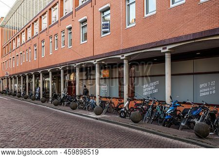 Zwolle, Overijssel, The Netherlands, 07 15 2022 - Facade Of The Coop Supermarket With A Row Of Parke