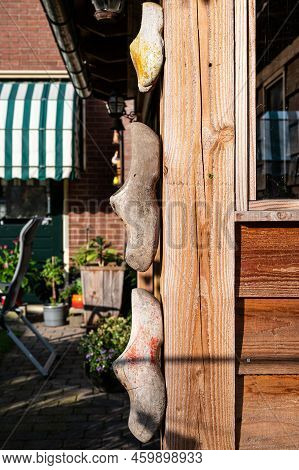 Stroe, Gelderland, The Netherlands, 07 12 2022 - Wooden Clogs As A Wall Decoration In A Garden Shed