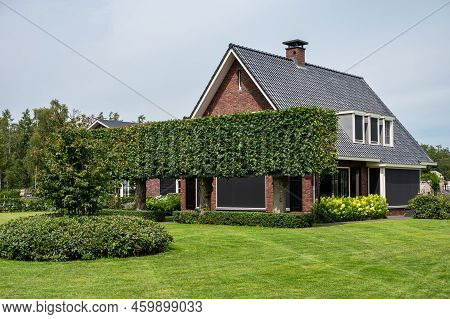 Harskamp, Gelderland, The Netherlands - 07 14 2022 - Country House With Front Yard, Surrounded By Tr