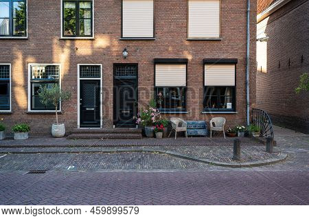 Zaltbommel, Gelderland, The Netherlands - 07 12 2022 - Traditional House Facade With A Bench And Sea