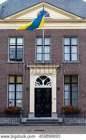 Zaltbommel, Gelderland, The Netherlands - 07 12 2022 - Classical Style Facade With An Ukrainian Flag