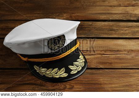 Peaked Cap With Accessories On Wooden Background, Space For Text