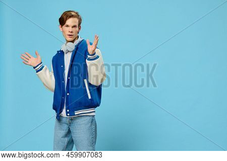 A Handsome Stylish Young Man In A Fashionable Bomber Jacket And With Headphones Around His Neck Stan